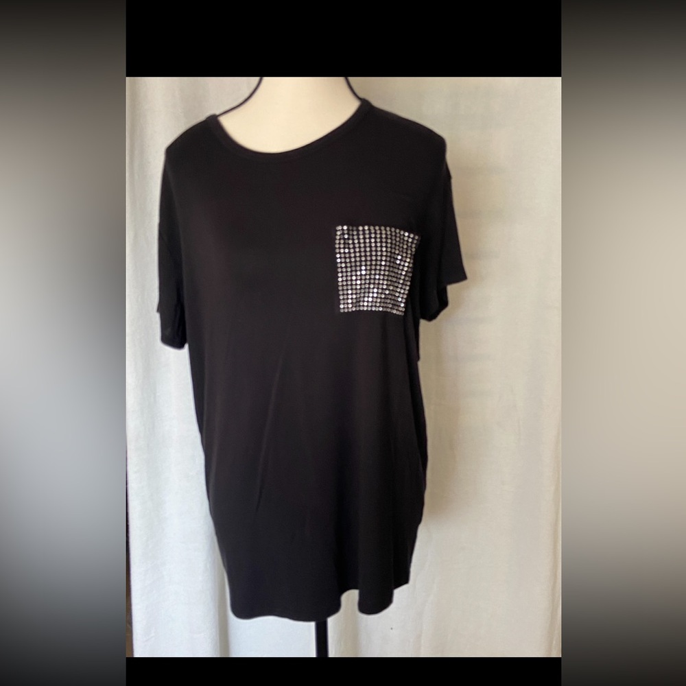 Black short sleeve tee shirt with front pocket covered with silver studs